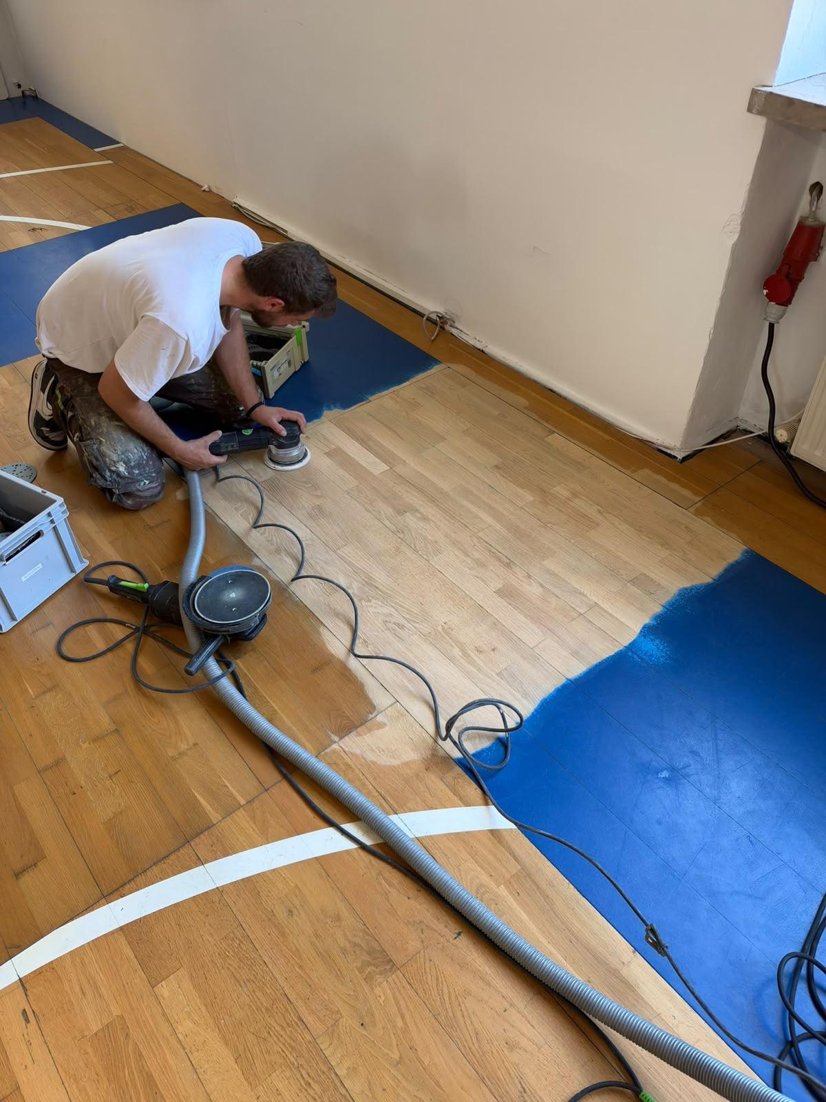 Sanding the recovered sports flooring